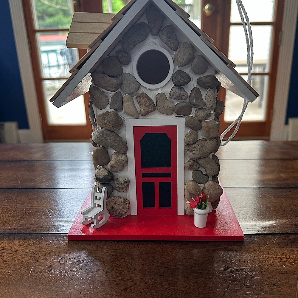 Charming Stone Birdhouse with Red Accents